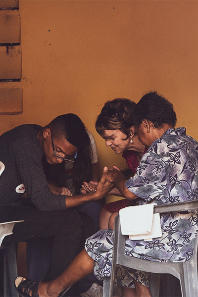 Missionary praying with people